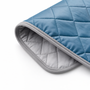 Macro of the bound edge showing the diamond quilting and pale grey reverse