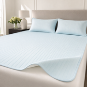 The Glacier ice silk cooling bed mat in Harbor Blue with matching pillowcases