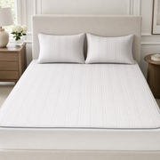 The Glacier ice silk cooling bed mat in Cloud Gray with matching pillowcases