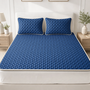 The Everest latex cooling mattress topper in Midnight Navy with matching pillow covers