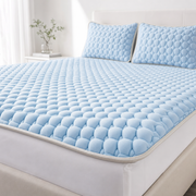 The Everest latex cooling mattress topper in Harbor Blue with matching pillow covers